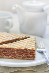 Wafer sheets filled with caramelized sugar and hazelnut cream served on white plate