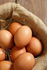 Fresh eggs on a wooden rustic background.