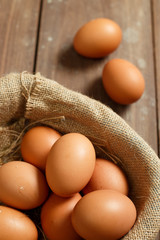 Fresh eggs on a wooden rustic background.