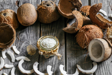 Fresh coconuts broken on wooden background