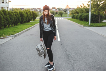 Beautiful and fashion young woman ride on a skateboard