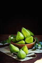 Fresh green figs, still life in rustic style, vintage wood backg