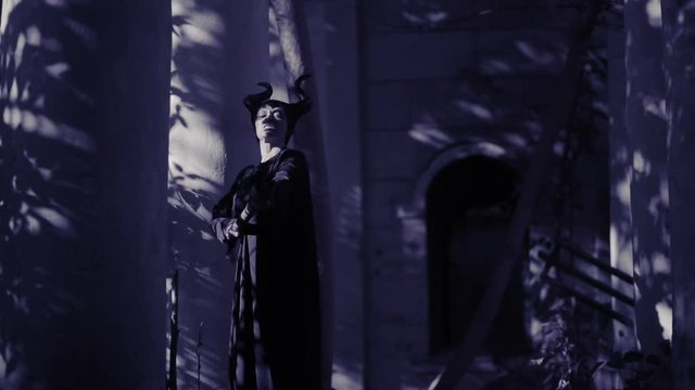 horned witch ghost walks through the ruins of the castle. halloween Horror