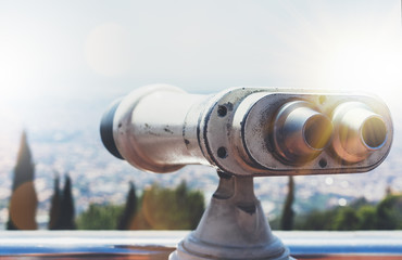 Touristic telescope look at the city with view of Barcelona Spain, close up old metal binoculars on background viewpoint overlooking the mountain, hipster coin operated in panorama observation, mockup