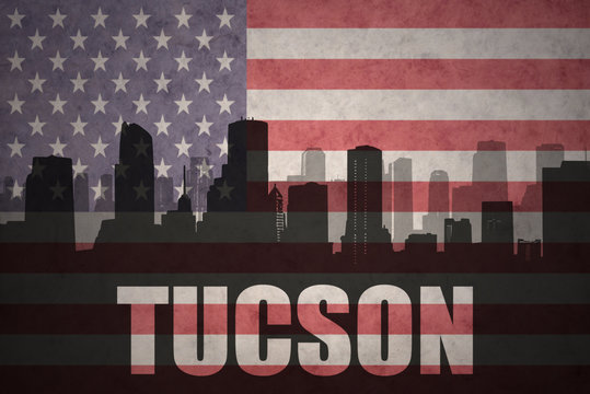 abstract silhouette of the city with text Tucson at the vintage american flag
