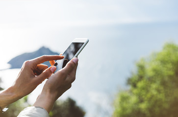 Hipster girl texting message on smartphone mobile close up, view tourist hands using gadget phone...