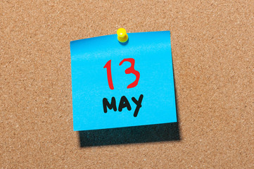 May 13th. Day 13 of month, calendar on cork notice board, business background. Spring time, empty...