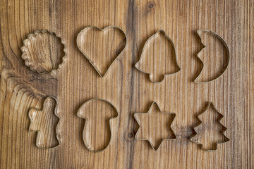 Christmas cookie cutters on wood