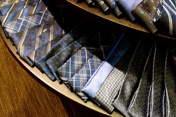 Obraz na płótnie Canvas Blue Hues Ties / Choices of blue and brown neckties laid out on a table.