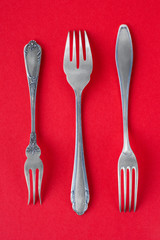 Victorian silver fork set on red background