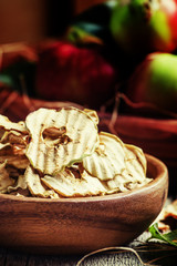 Apple chips, still life in rustic style, vintage wooden backgrou