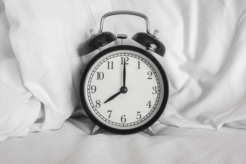 Still life with vintage alarm clock on bed ( alarm clock show 8