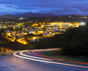 Car lights in the city at night .