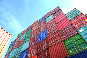 Containers for packaging used for referral to a trailer or cargo ship to transport goods.  Blue sky and Plane