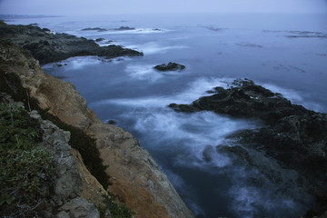 Fototapeta na wymiar dusk ocean water swirling rocks