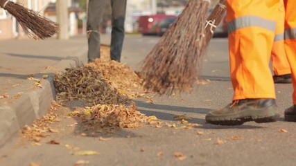 street cleaner sweeping autumn park, low-paid job, no prospects in life