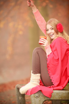 Girl with red cup in park.