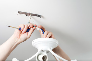 Electrician repairing luster in the house. Lightening