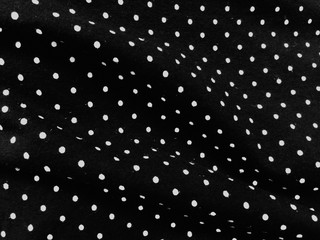 Black and white polka dot fabric background