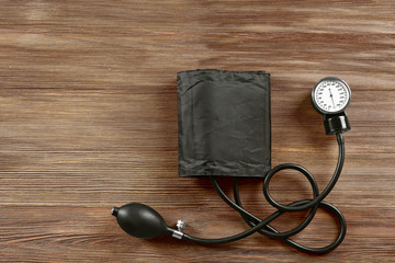 Medical manometer on a wooden background