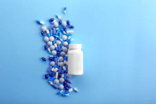 Heap of pills on blue background