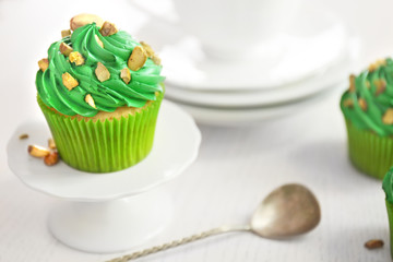 Green pistachio cupcake on white stand