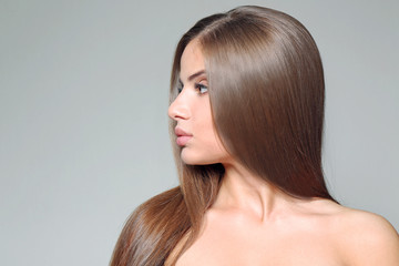 Young woman with healthy hair on color background