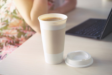 Coffee-to-go. Opened paper cup of coffee on table