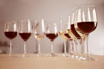 Glasses with red and white wine on table in restaurant