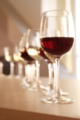 Glasses with red and white wine on table in restaurant