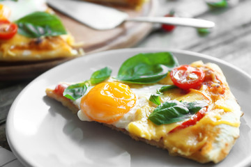 Margarita pizza with basil leaves and egg on plate closeup