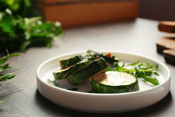 Baked squash slices in plate on table