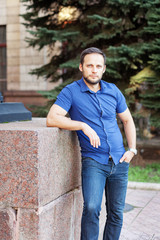 Fototapeta premium Portrait of stylish handsome young man with bristle standing