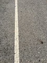 white line on black asphalt road texture background