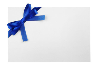 Blue satin ribbon and card on light background