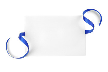 Blue satin ribbon and card on light background