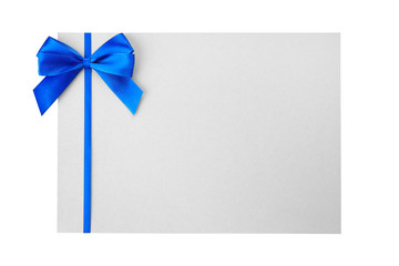 Blue satin ribbon and card on light background