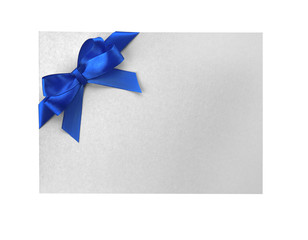 Blue satin ribbon and card on light background