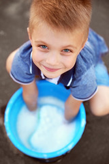 Cute boy with bucket and sponge, closeup