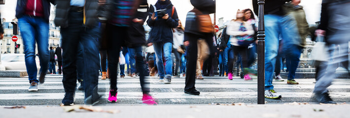 crowd of people crossing a city street