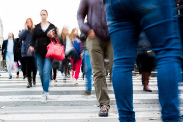 crowd of people crossing a city street