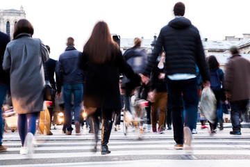 crowd of people crossing a city street