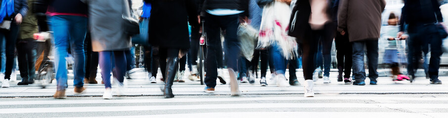 crowd of people crossing a city street