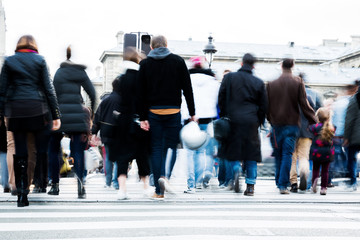 crowd of people crossing a city street