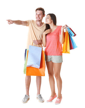 Happy couple with purchases isolated on white