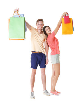 Happy couple with purchases isolated on white