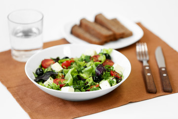 Plate of fresh delicious salad on napkin, closeup