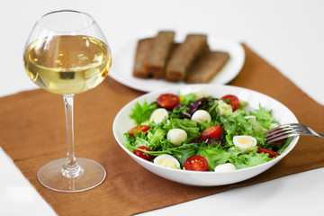 Plate of fresh delicious salad on napkin, closeup