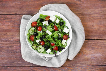 Plate of fresh delicious salad on napkin