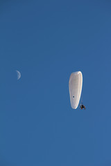 Paramotor in a blue sky with little moon